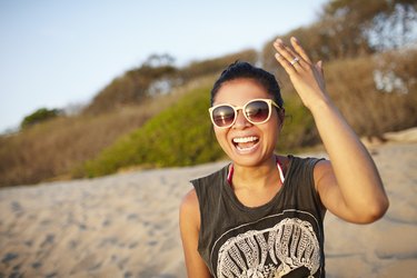 Young women laughing on beach, Costa Rica