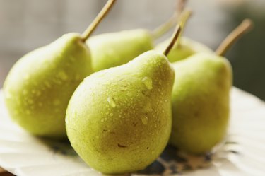 Green pears on a white plate