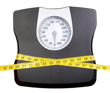 Bathroom scale with a measuring tape