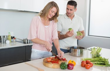 Couple preparing food in kitchen