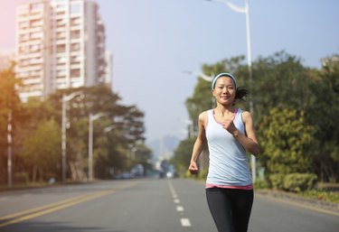 fit sports woman running at street