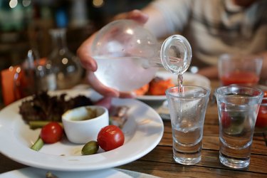 Person pouring vodka from the decanter