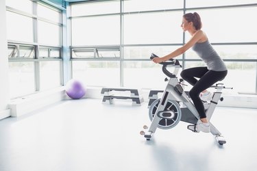 Woman riding an exercise bike