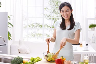 Young woman cooking in kitchen