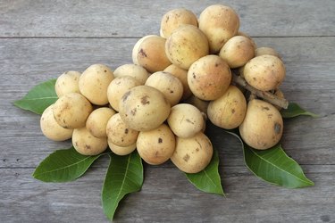 Bunch of sweet Longong fruit and leaves on the table