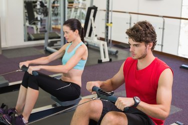 Man and woman working out on the rowing machine