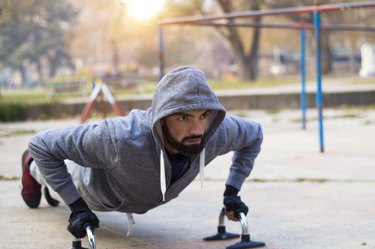 Young athlete working out in an outdoor gym and lead a healthy life