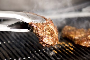 grilling steak on BBQ almost ready