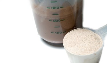 Chocolate protein shake with a scoop of  protein powder isolated