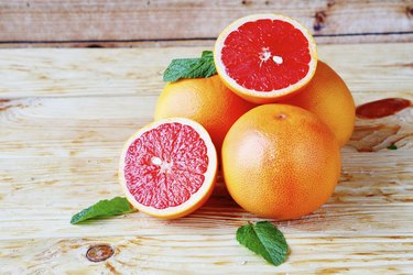 heap ripe grapefruit on a wooden background