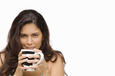 Portrait of a young woman holding a mug of coffee