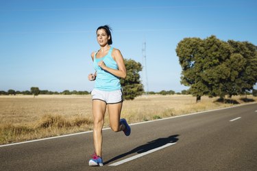 Fit woman running on road