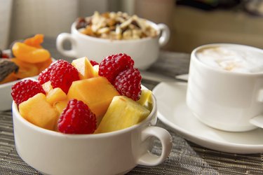 Fresh fruit and oatmeal with healthy toppings for breakfast