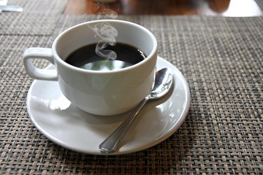 Hot Black coffee in a white cup on the table.