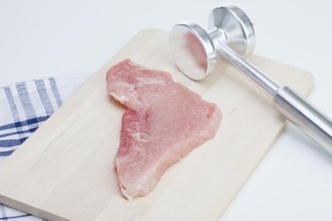 Raw cutlet and meat tenderizer
