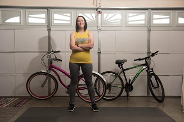 Lacey stands in front of her bikes.