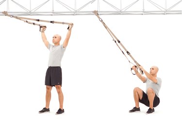 Man doing Squat Y Fly on the TRX Suspension Trainer