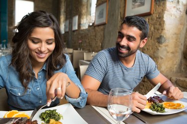 Happy couple eating dinner together at a restaurant