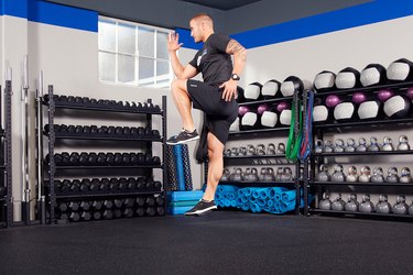 Man performing knee drive warm-up exercise