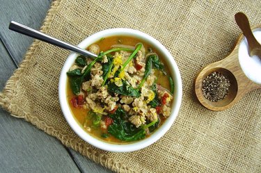 A hot cereal bowl with oats and greens