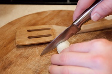 a close up of a hand slicing open a gnocchi