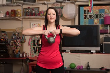 Lacey holds a kettleball.