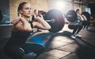 woman lifting weights in a crossfit class