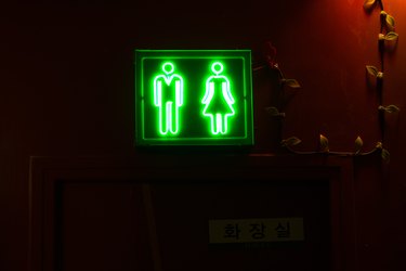 neon green restroom sign