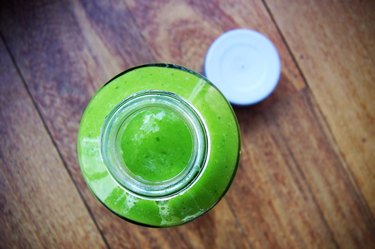 Top view of a green smoothie in a glass jar