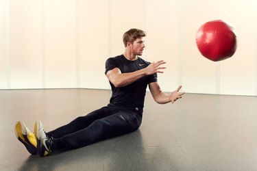 Man Demonstrating How to Do a Medicine Ball Lateral Scoop
