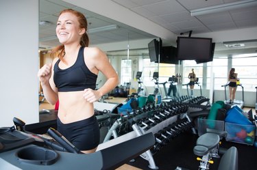 smiling woman running on the treadmill