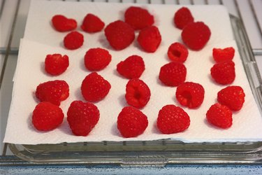 raspberries on paper towels in the fridge