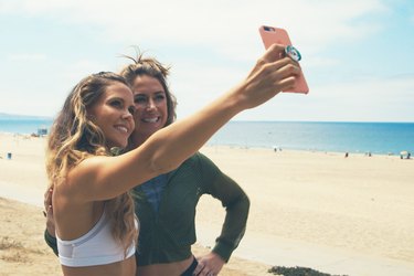 Katrina Scott and Karena Dawn take a selfie on Manhattan Beach, California