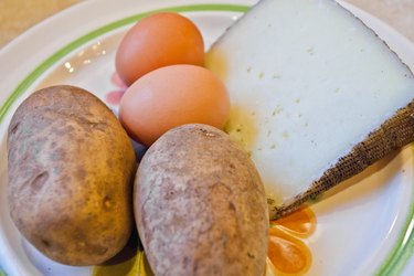 potatoes, eggs and cheese on a plate