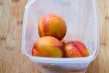 whole peaches in plastic container