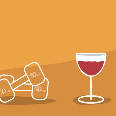 Glass of wine next to weights