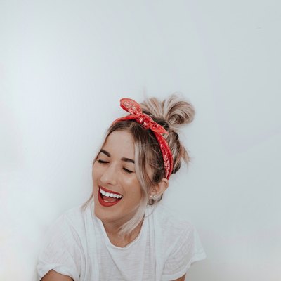 woman smiling in front of white wall