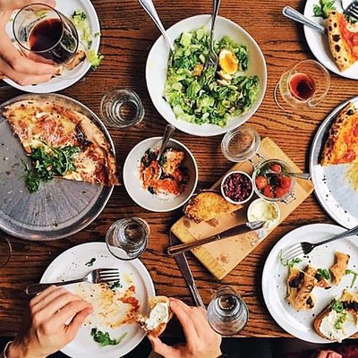 American foods like pizza and Cobb salad spread out on a table