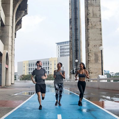 friends running on a paved road