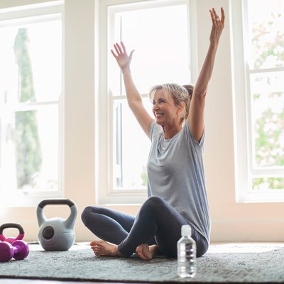 woman doing weight-loss workout at home on yoga mat