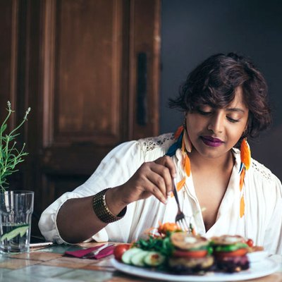 A woman eating a healthy meal at home