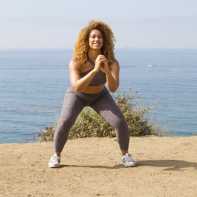 Woman demonstrating proper squat form for the squat challenge