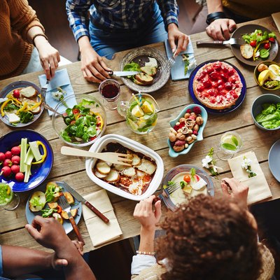 Top view of friends eating dinner around the table