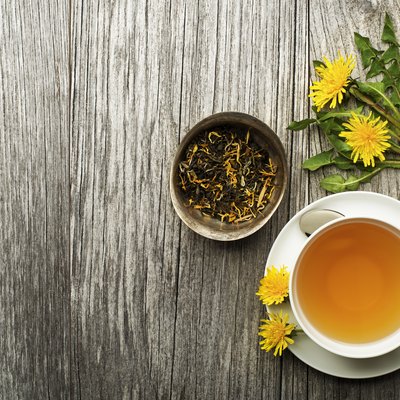 cup of dandelion tea on a wooden table