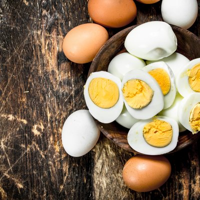 Hard-boiled eggs in a bowl on a wooden table