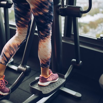 Woman using elliptical trainer