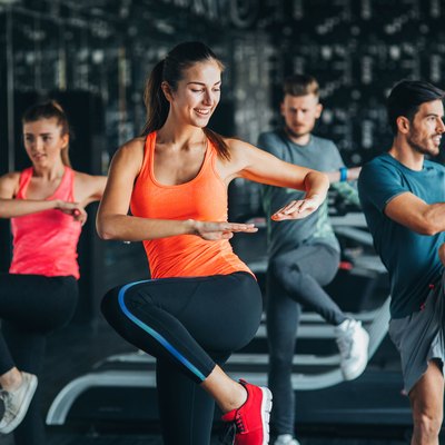 Women and men doing moves in an aerobic class