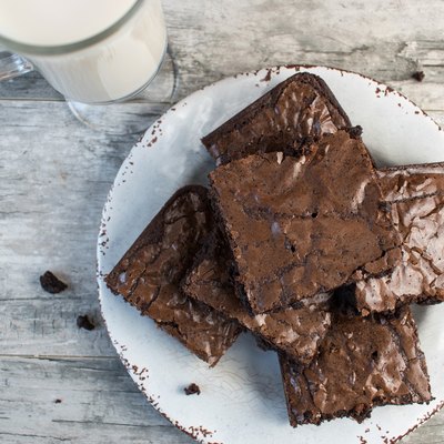 Chocolate brownies on white plate with milk