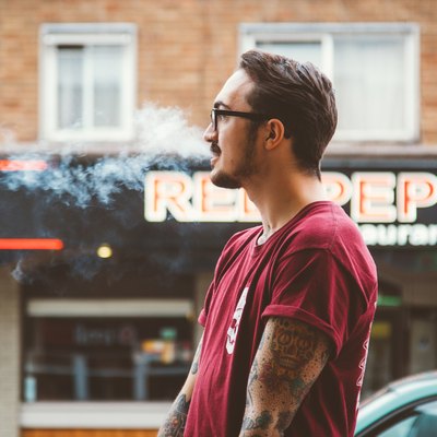 man smoking on the street