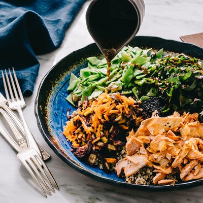 Gluten-free soy sauce pouring on a plate of food